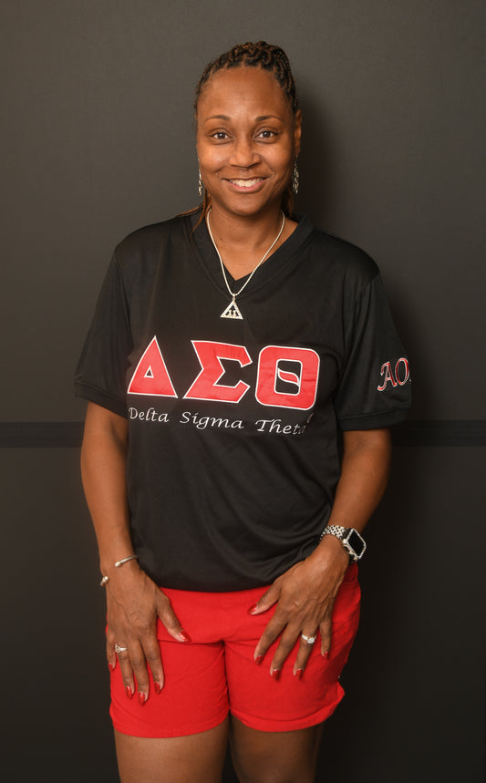 Woman wearing a black Delta Sigma Theta V neck shirt with AOML on the sleeve