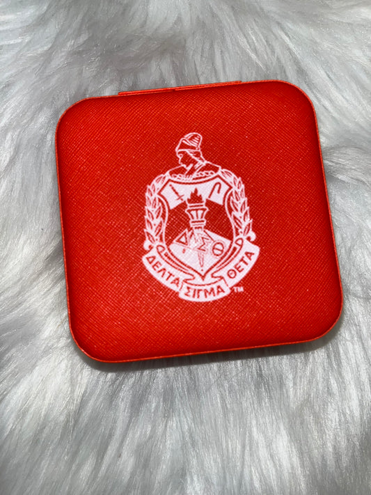 Red portable travel jewelry box with a compact mirror