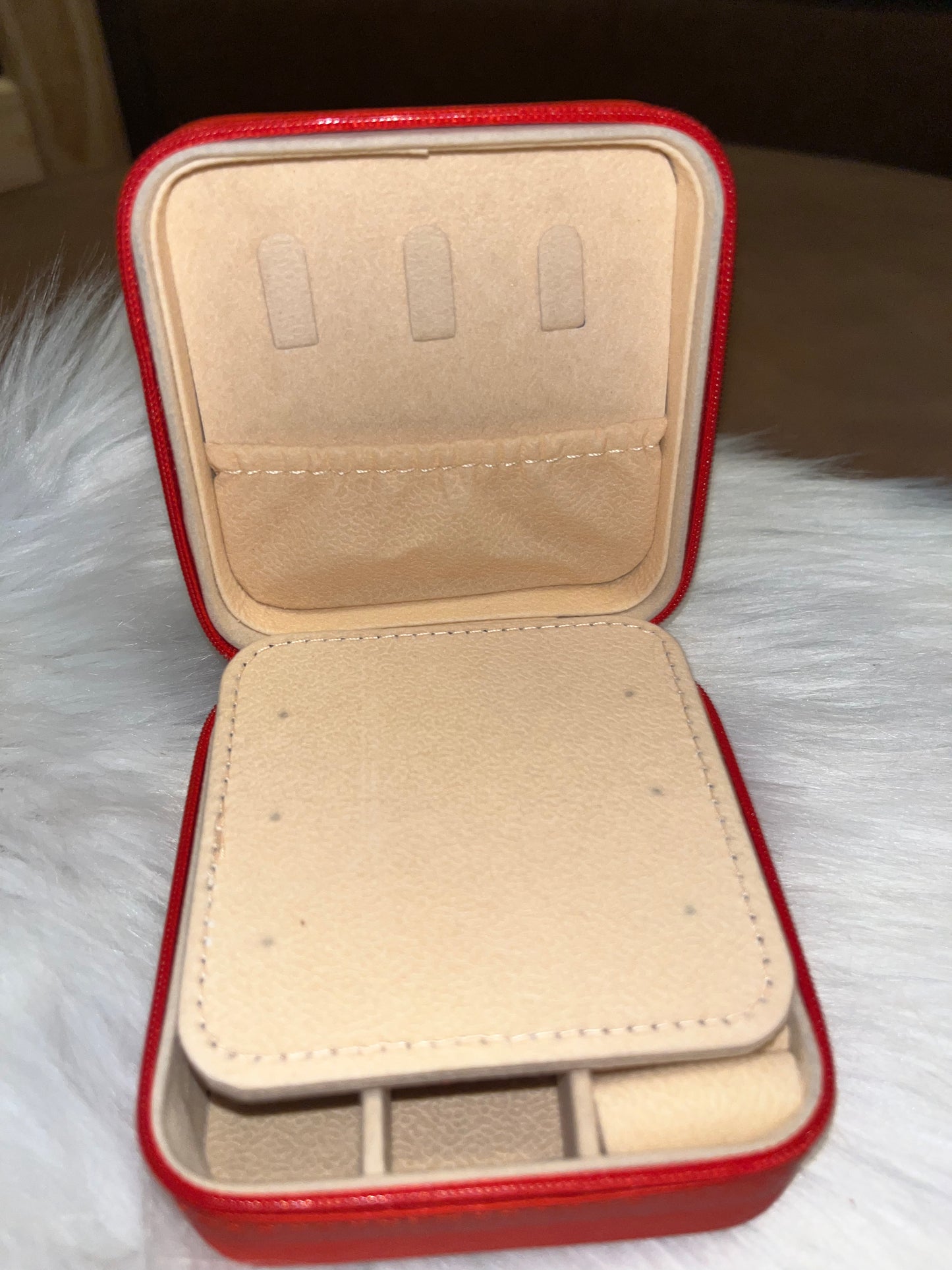 Red portable travel jewelry box with a compact mirror