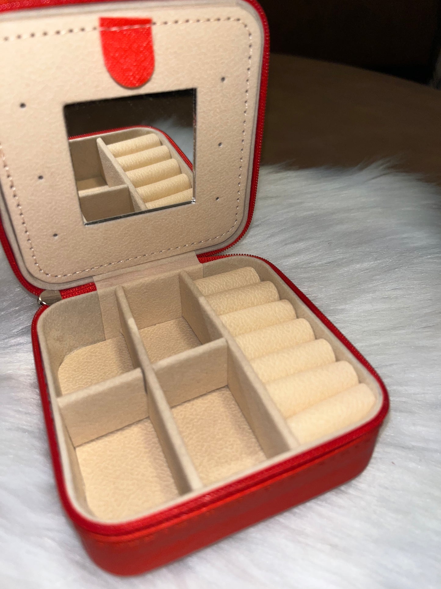 Red portable travel jewelry box with a compact mirror