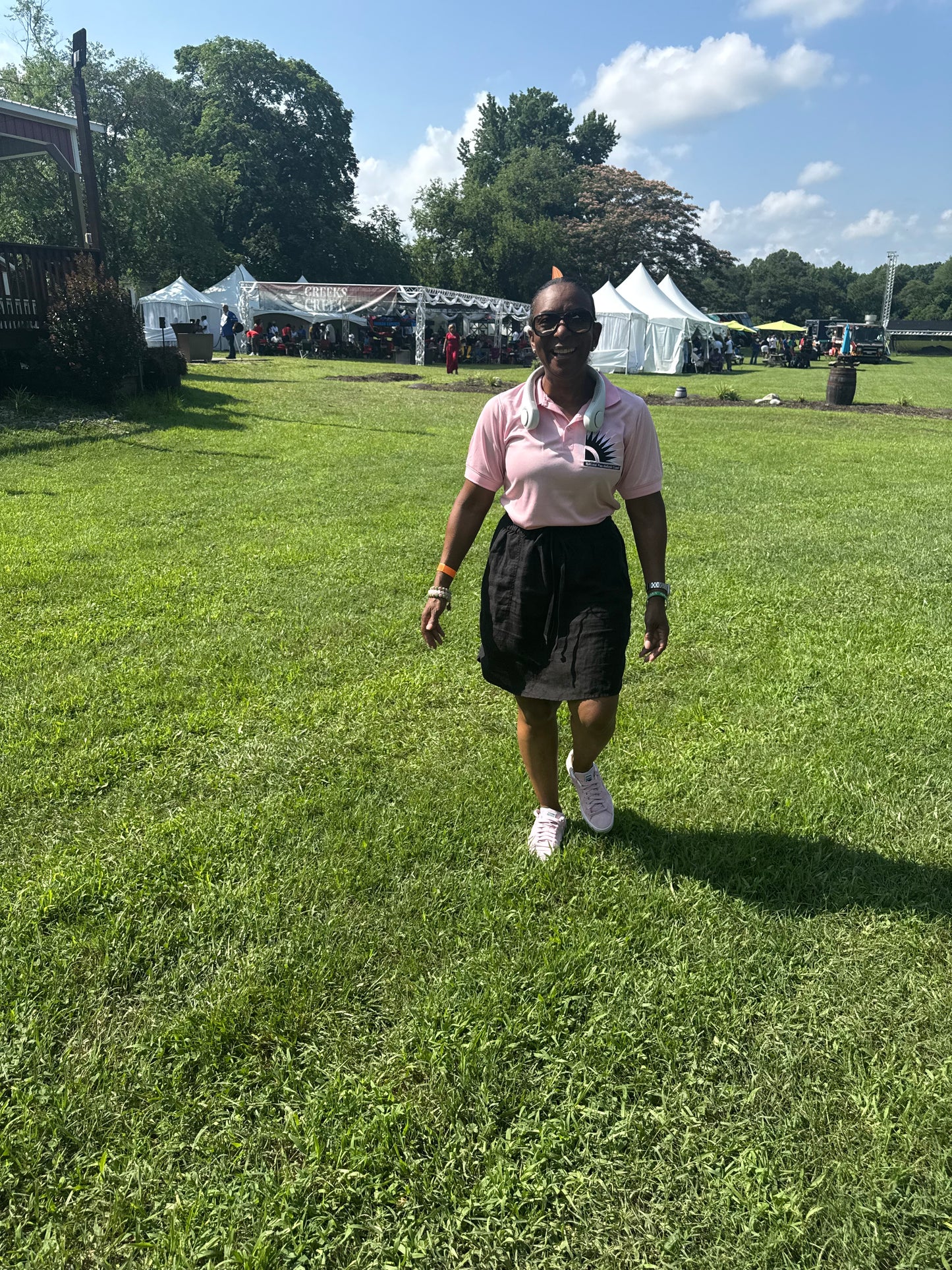 Pink polo shirt with NPHC embroidered logo