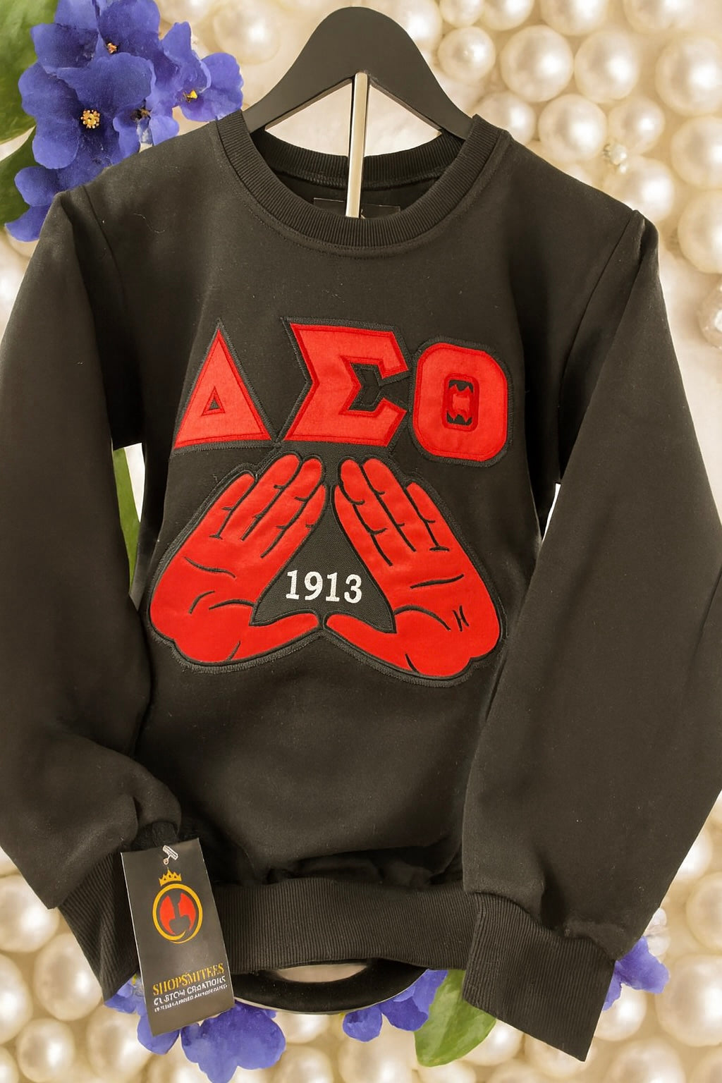sleek black women’s crewneck with DST symbols with 1913 centered in the mids that are raised up across the chest