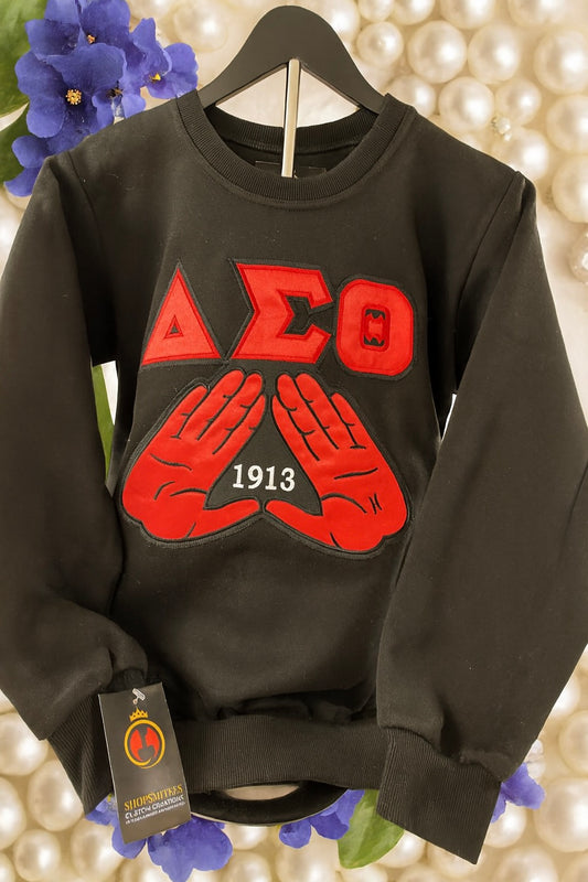 sleek black women’s crewneck with DST symbols with 1913 centered in the mids that are raised up across the chest